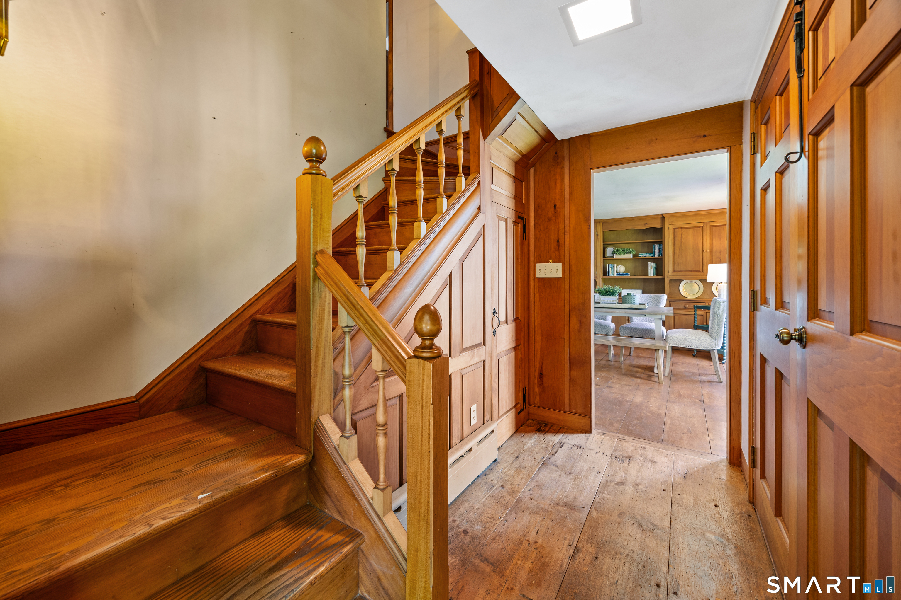 52 Susan Lane Meriden, CT 06450 - Photo 3 of 28 a view of a hallway with wooden floor and staircase