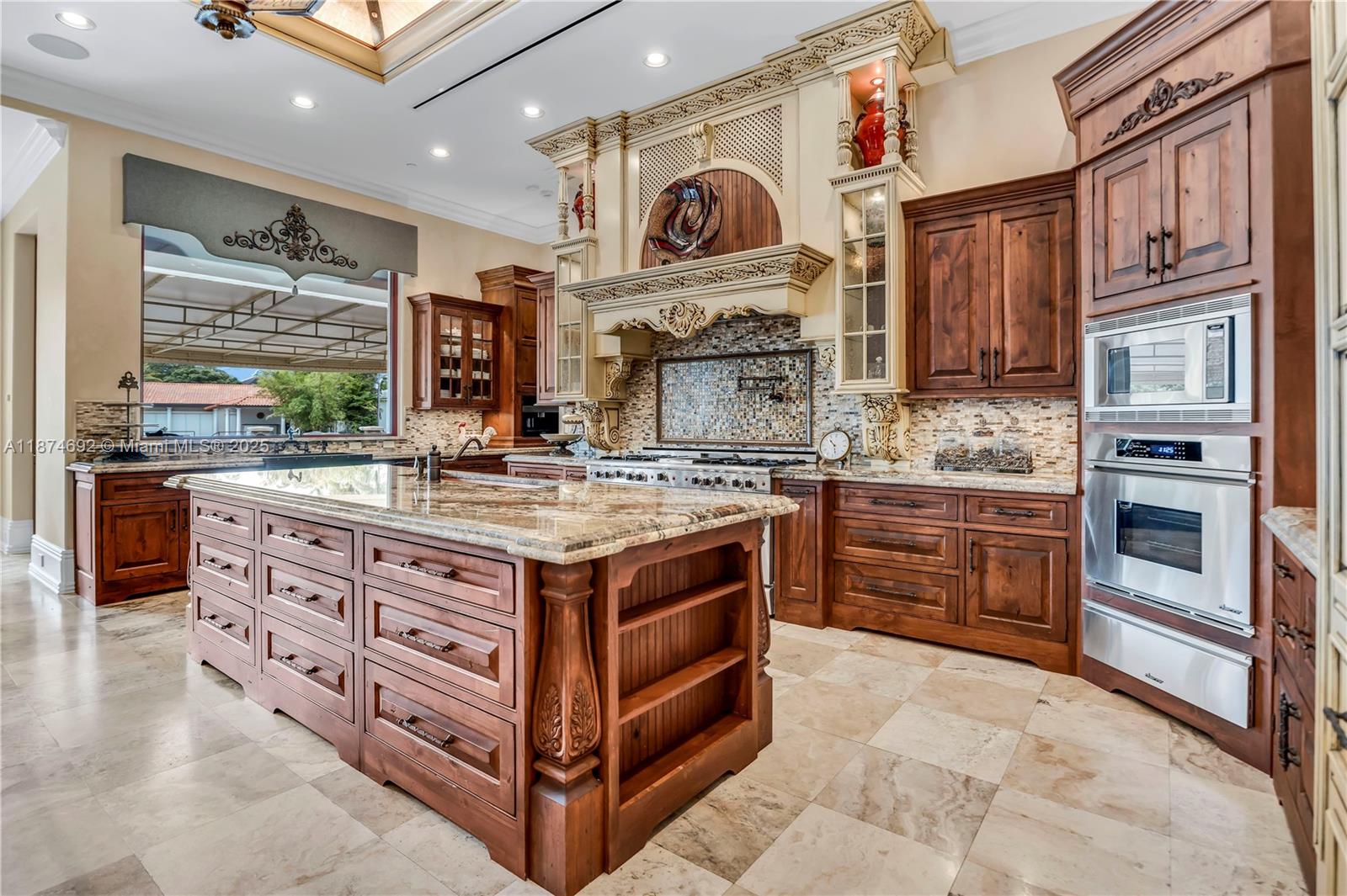 700 47th Street Boca Raton, FL 33431 - Photo 21 of 73 a kitchen with stainless steel appliances granite countertop a stove and cabinets