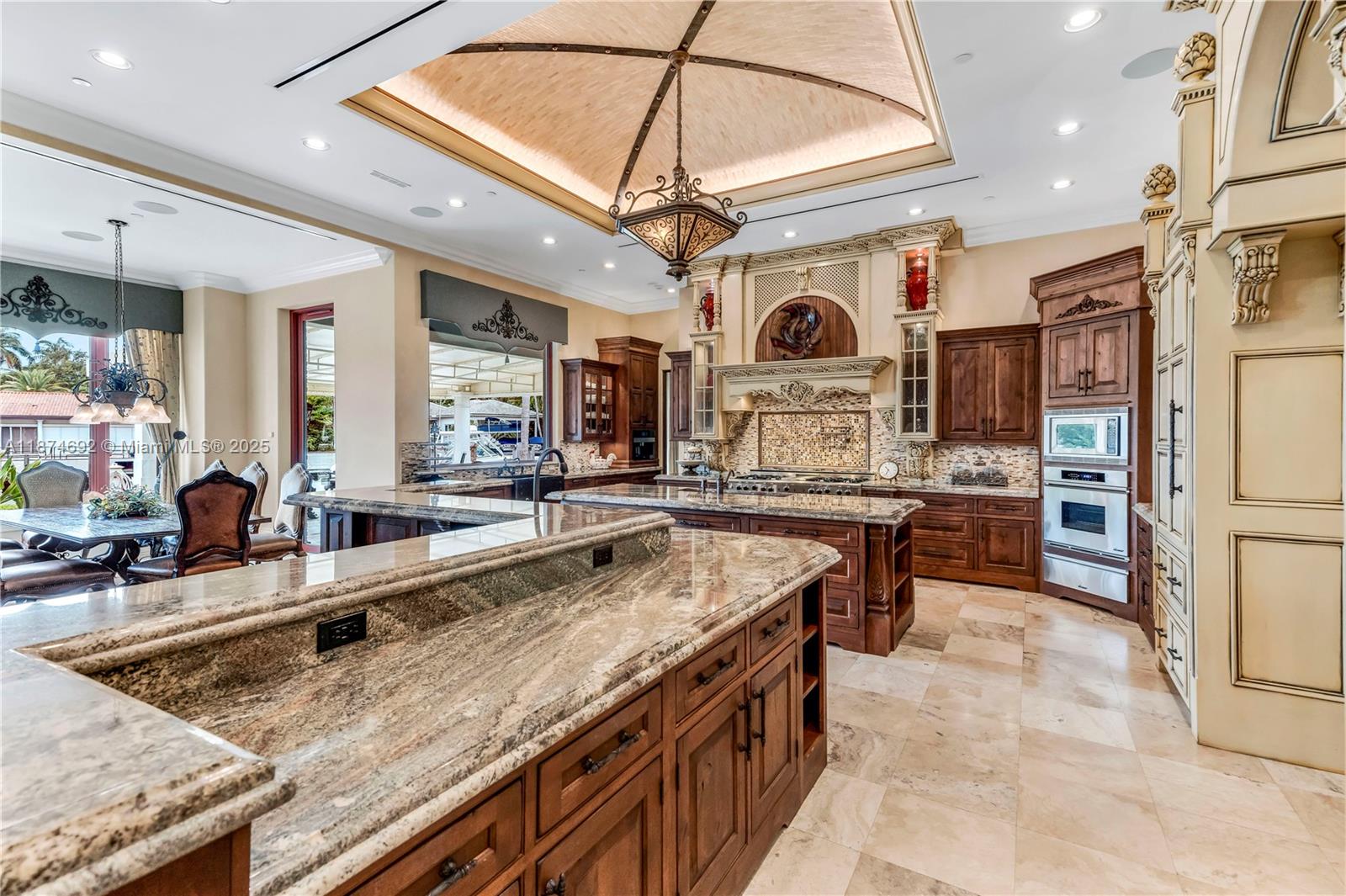 700 47th Street Boca Raton, FL 33431 - Photo 23 of 73 a kitchen with stainless steel appliances granite countertop a sink a stove and a refrigerator