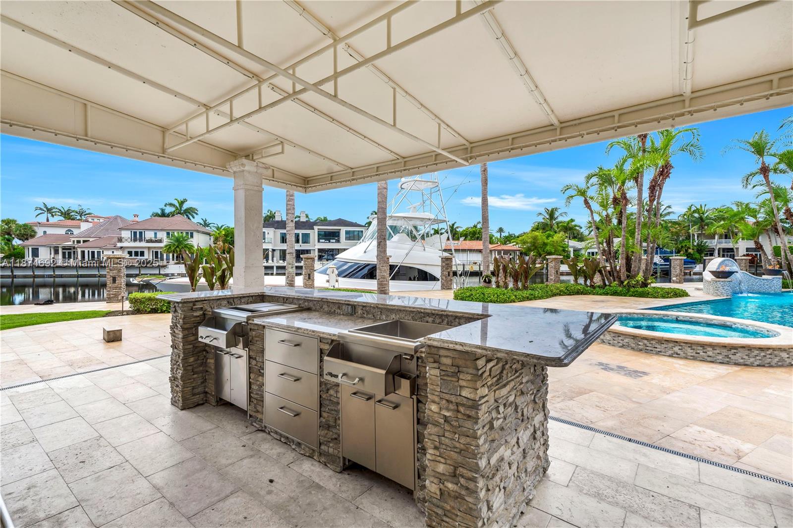 700 47th Street Boca Raton, FL 33431 - Photo 37 of 73 a kitchen with stainless steel appliances granite countertop a sink and a stove