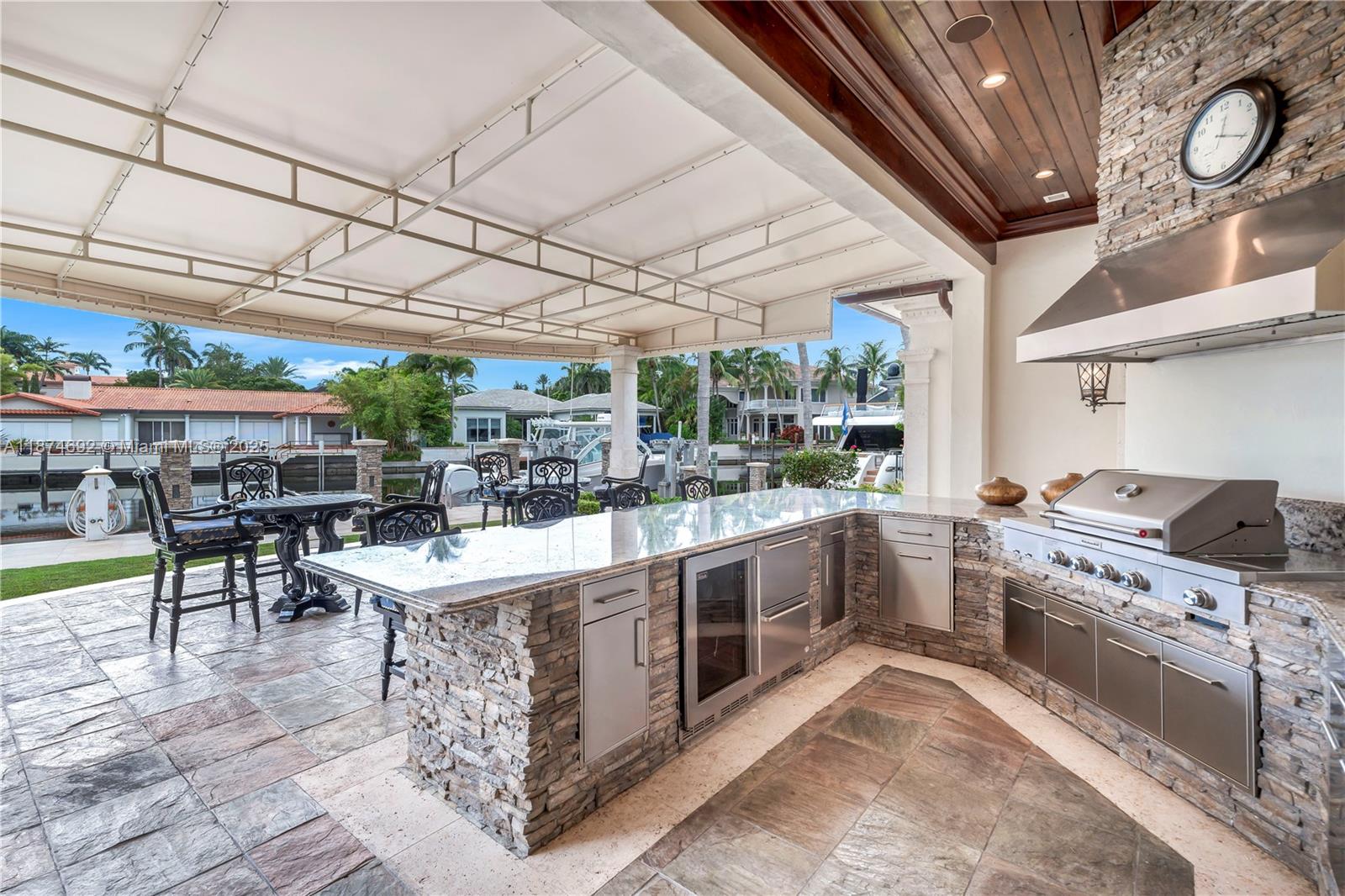 700 47th Street Boca Raton, FL 33431 - Photo 40 of 73 a kitchen with stainless steel appliances granite countertop a sink and stove top oven