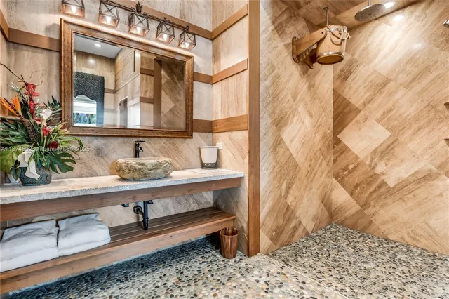 a bathroom with a sink a mirror and a shower