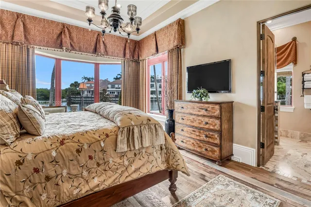 a bedroom with furniture a bed and a wooden floor