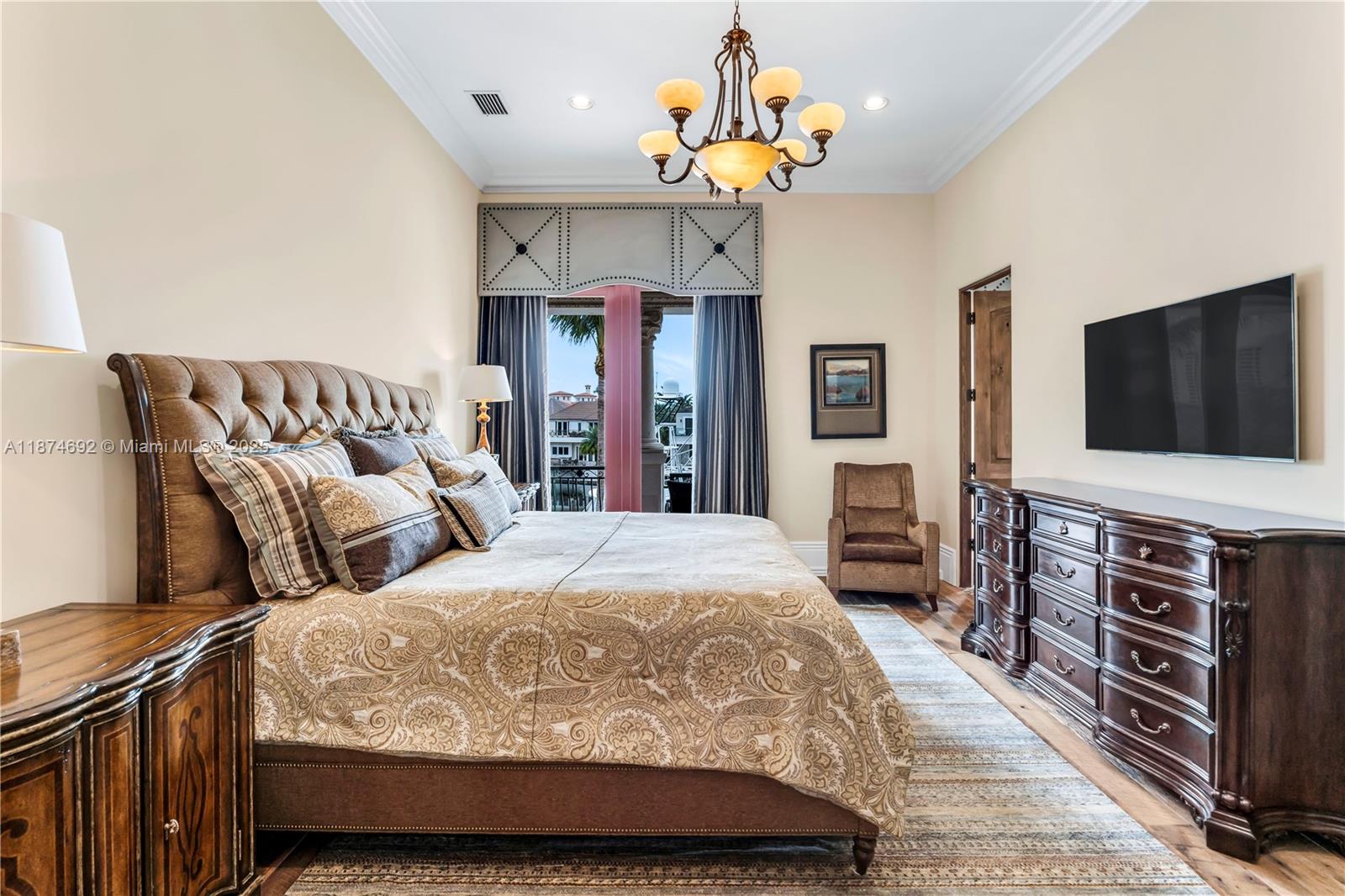 700 47th Street Boca Raton, FL 33431 - Photo 46 of 73 a bedroom with a bed and a flat tv screen on dresser