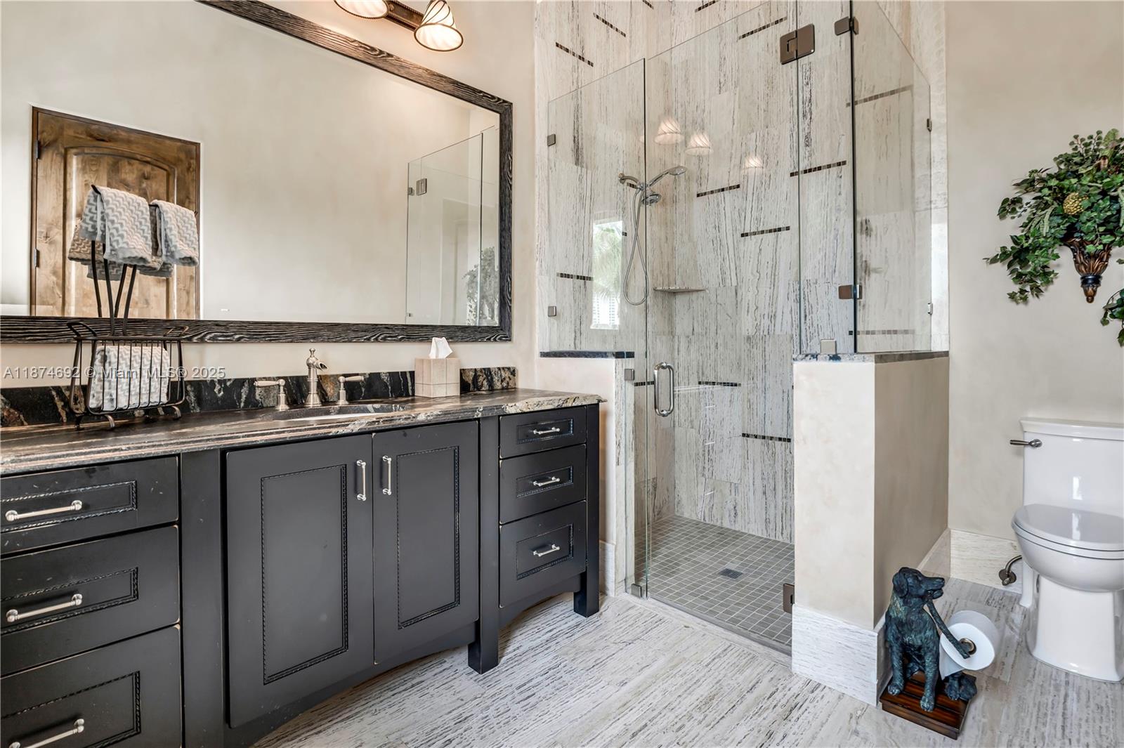 700 47th Street Boca Raton, FL 33431 - Photo 47 of 73 a spacious bathroom with a double vanity sink toilet mirror and shower