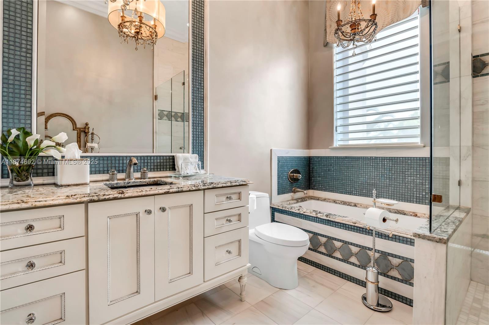 700 47th Street Boca Raton, FL 33431 - Photo 50 of 73 a spacious bathroom with a granite countertop sink and a mirror