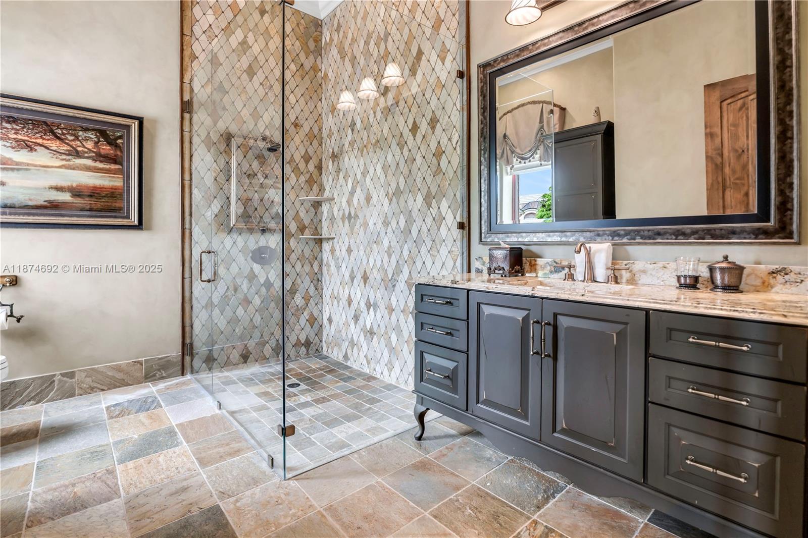 700 47th Street Boca Raton, FL 33431 - Photo 52 of 73 a bathroom with a sink a mirror and a shower