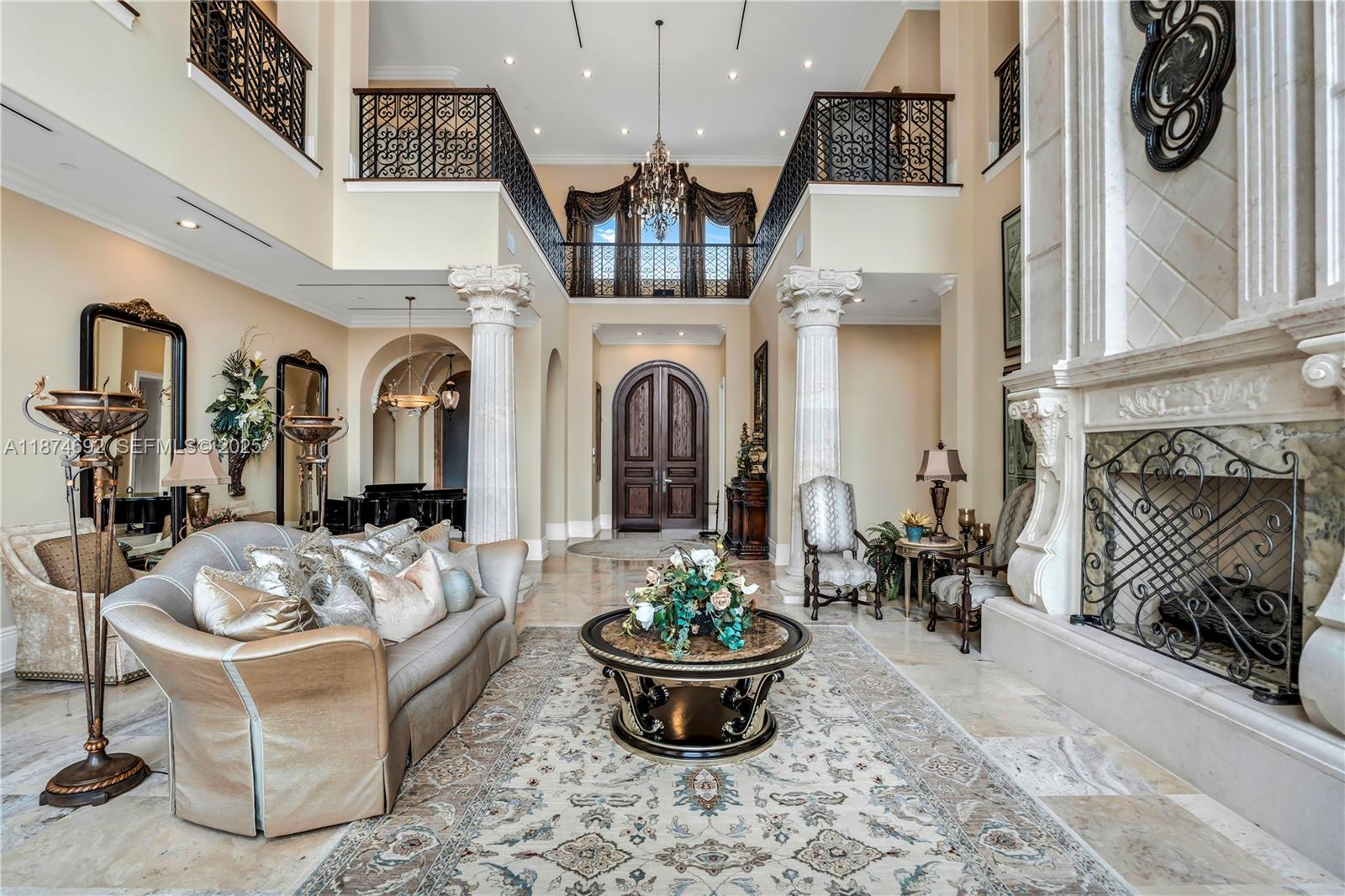700 47th Street Boca Raton, FL 33431 - Photo 8 of 73 a living room with furniture a fireplace and a chandelier