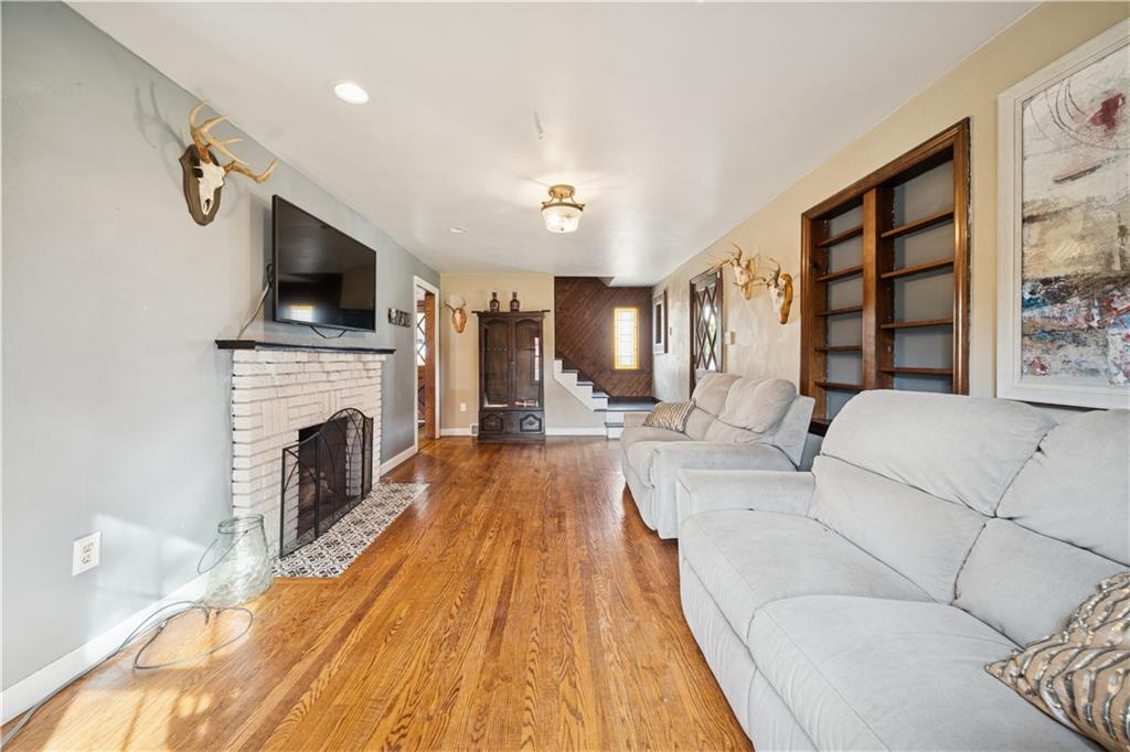 1512 Abers Creek Road Pittsburgh, PA 15239 - Photo 19 of 39 a living room with furniture a fireplace and a flat screen tv