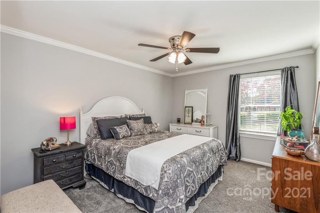 8619 Unity Church Road Denver, NC 28037 - Photo 15 of 24 a bedroom with a bed and a chandelier