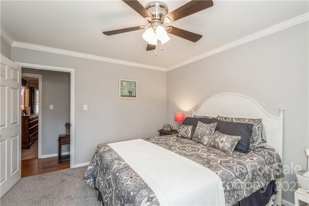 8619 Unity Church Road Denver, NC 28037 - Photo 16 of 24 a bedroom with a bed and a chandelier