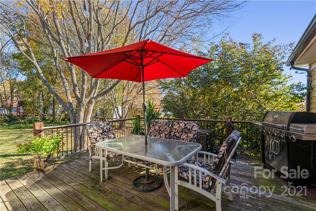 8619 Unity Church Road Denver, NC 28037 - Photo 23 of 24 an outdoor sitting area with furniture and umbrella