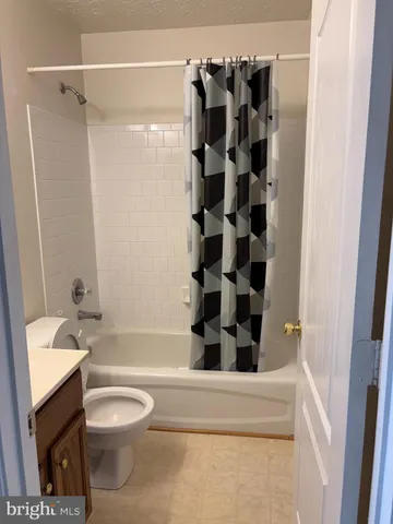 a bathroom with a shower a toilet and a sink
