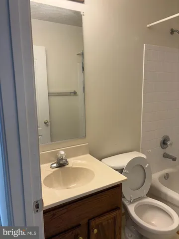 a bathroom with a sink toilet and mirror