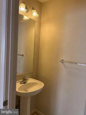a bathroom with a sink mirror and vanity