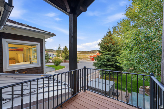 8650 Redden Road Park City, UT 84098 - Photo 23 of 71 Balcony with wood-finish decking, wrought iron railing, and dark-stained support beams