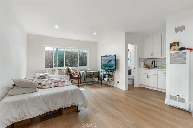 a kitchen with white cabinets and white appliances