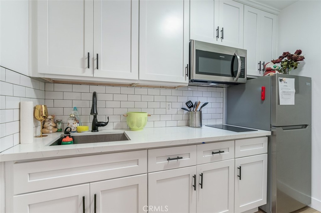 259 North Euclid Avenue Pasadena, CA 91101 - Photo 21 of 33 a kitchen with white cabinets and white appliances