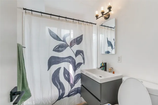 a kitchen with stainless steel appliances kitchen island granite countertop a refrigerator stove top oven and sink