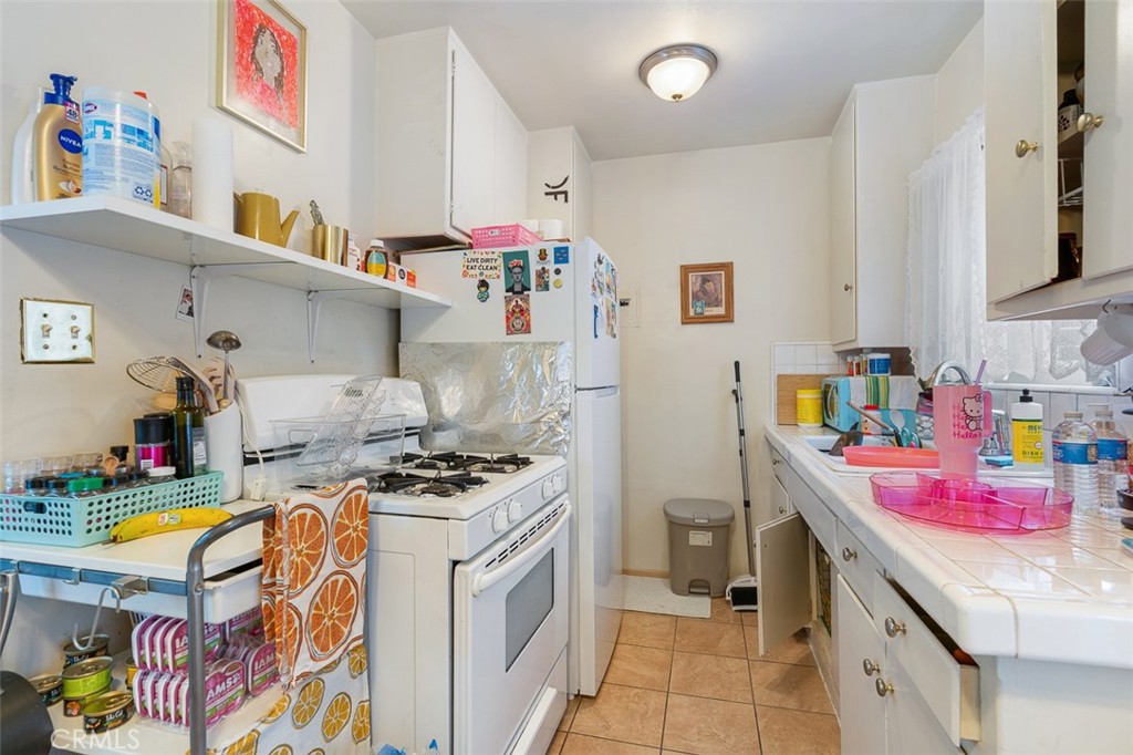 259 North Euclid Avenue Pasadena, CA 91101 - Photo 30 of 33 a kitchen with stainless steel appliances a stove a sink and a refrigerator