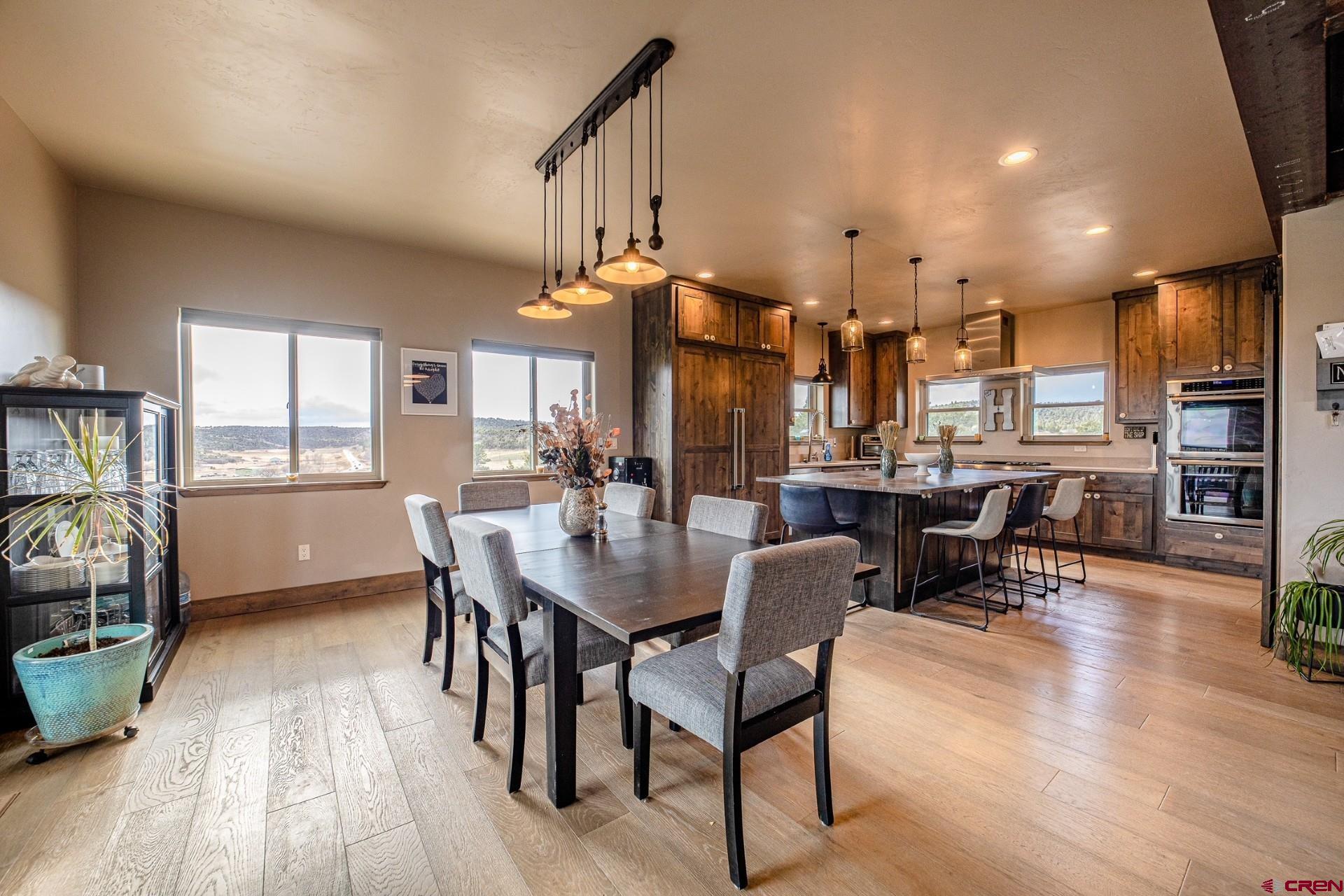 492 Fox Fire Ridge Road Bayfield, CO 81122 - Photo 11 of 44 a view of a dining room with furniture and wooden floor