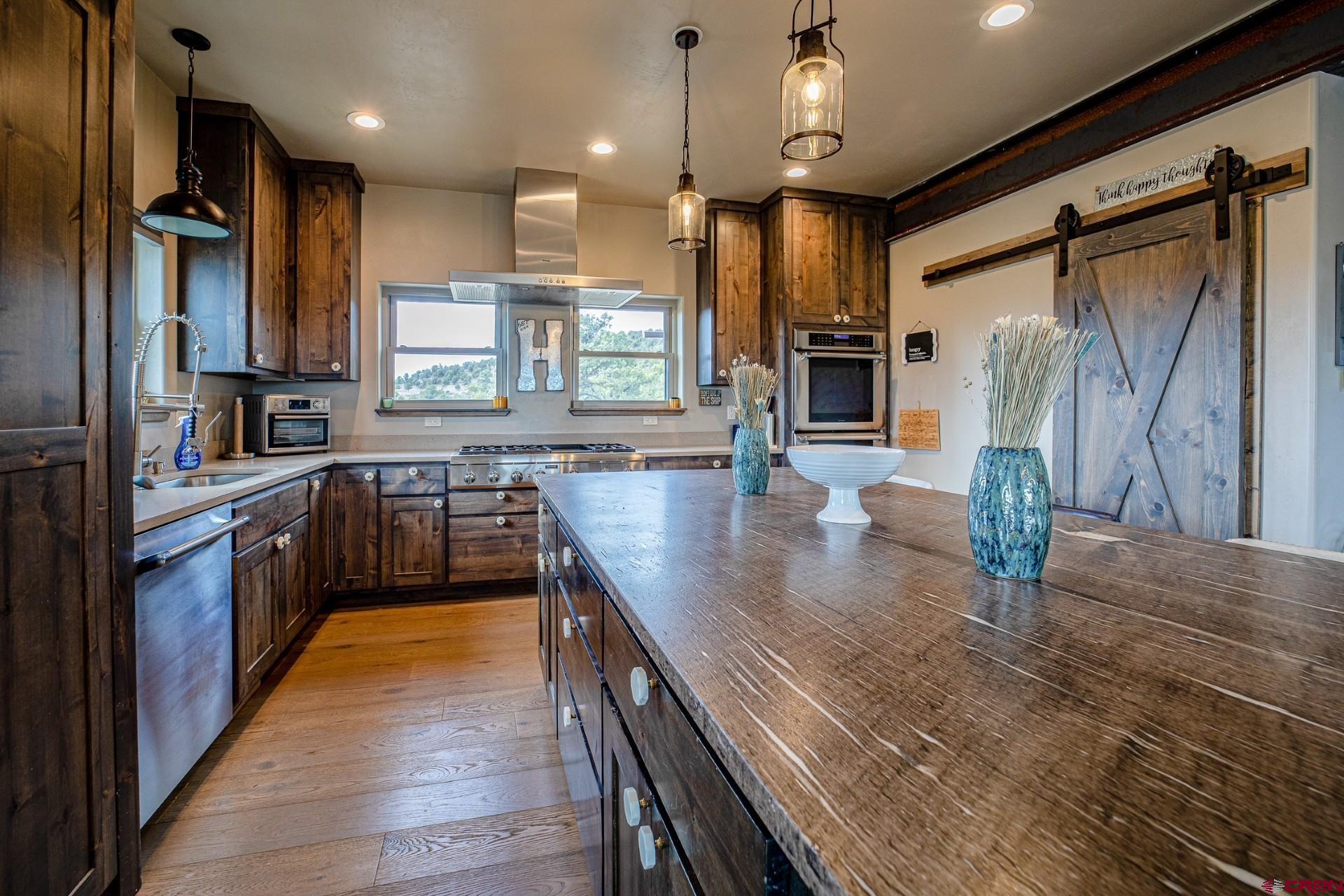 492 Fox Fire Ridge Road Bayfield, CO 81122 - Photo 12 of 44 a kitchen with stainless steel appliances granite countertop sink stove top oven and refrigerator