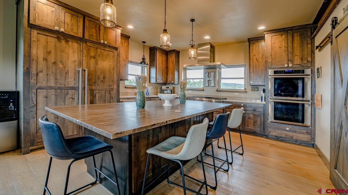 492 Fox Fire Ridge Road Bayfield, CO 81122 - Photo 18 of 44 a dining table with chairs and kitchen view