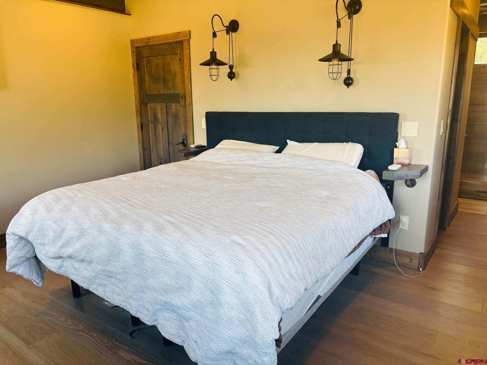 492 Fox Fire Ridge Road Bayfield, CO 81122 - Photo 19 of 44 a large bed sitting in a bedroom next to a bathroom