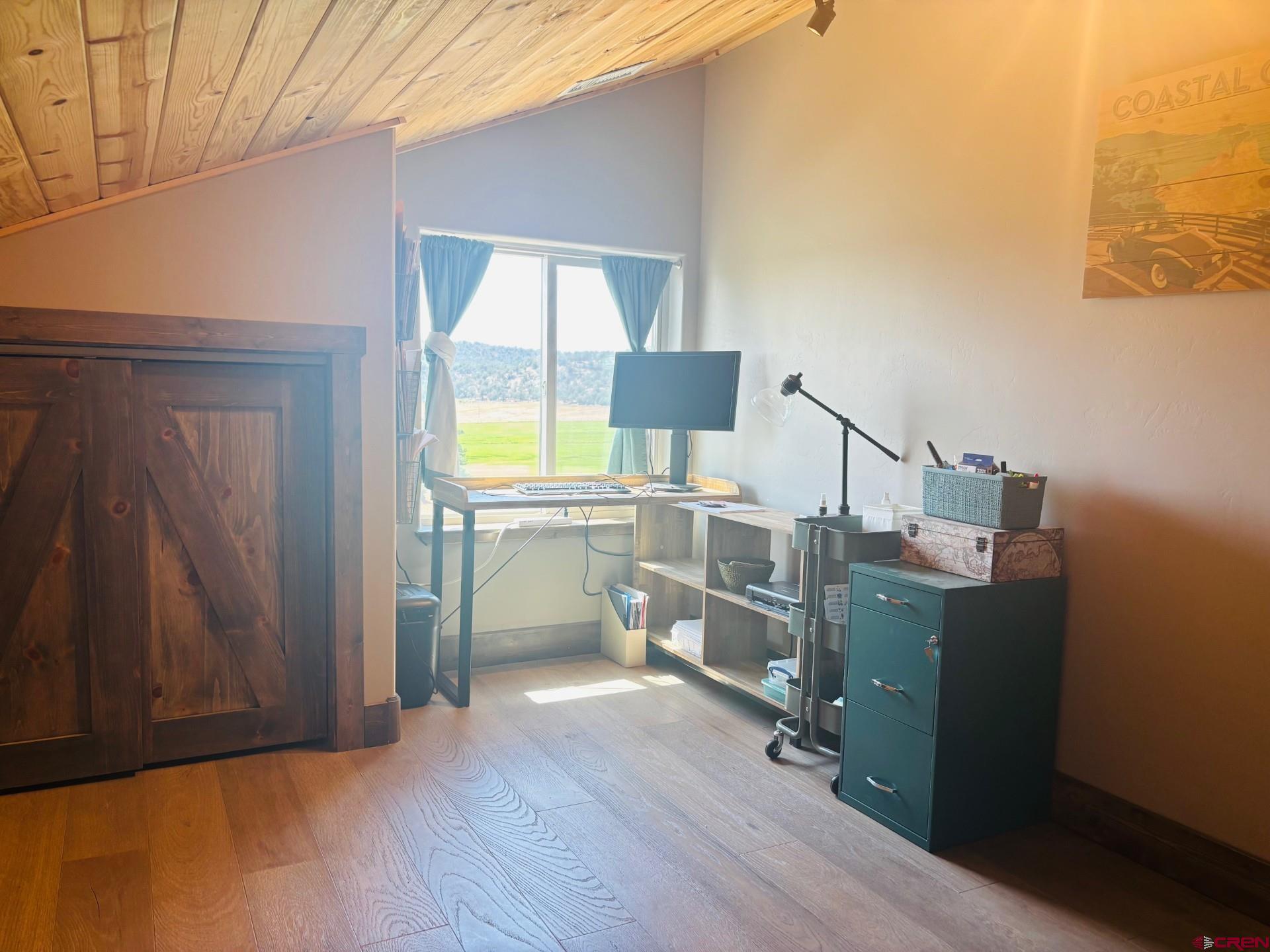 492 Fox Fire Ridge Road Bayfield, CO 81122 - Photo 27 of 44 a room with cabinets and wooden floor
