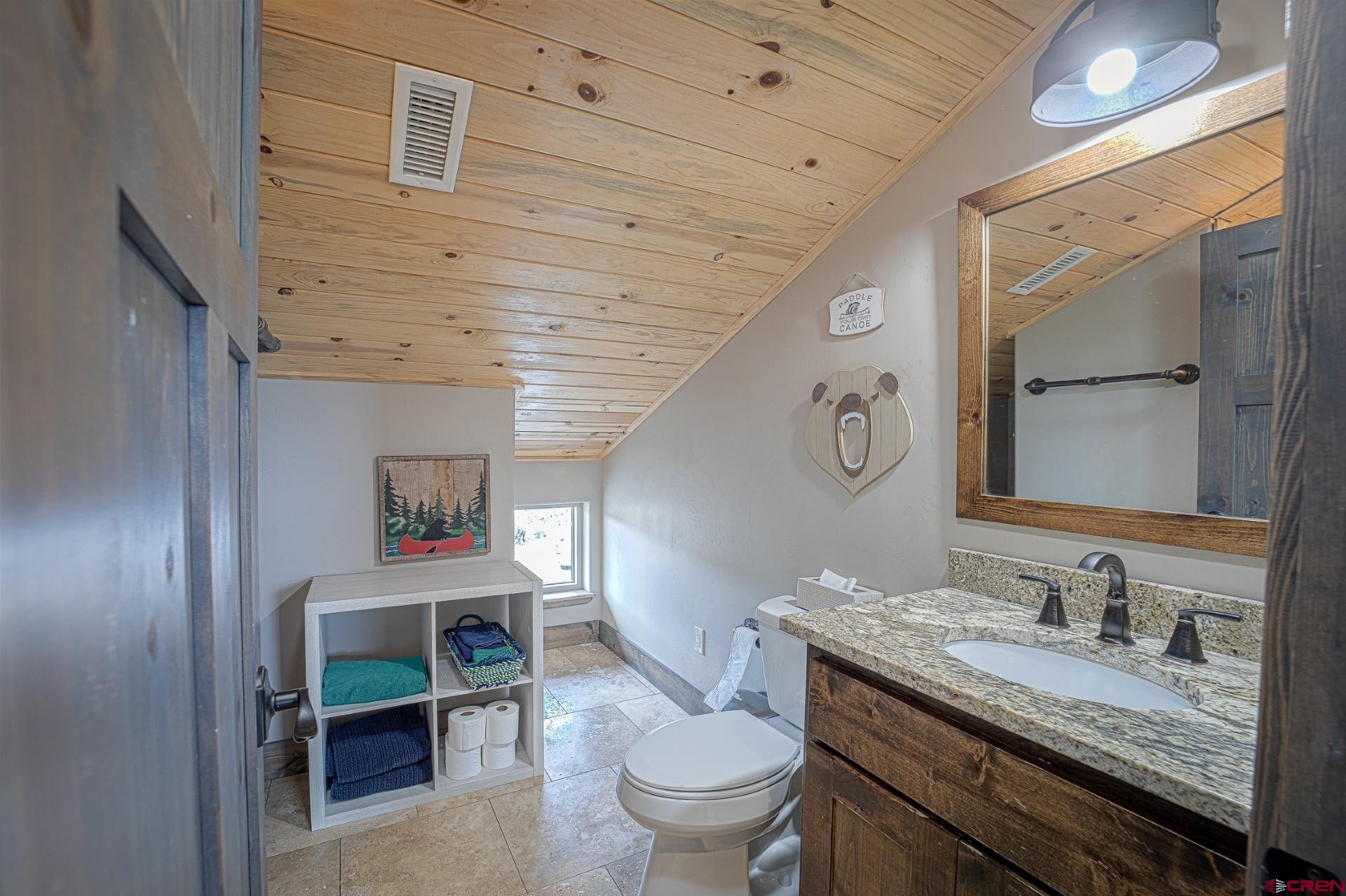 492 Fox Fire Ridge Road Bayfield, CO 81122 - Photo 29 of 44 a bathroom with a granite countertop toilet sink and mirror