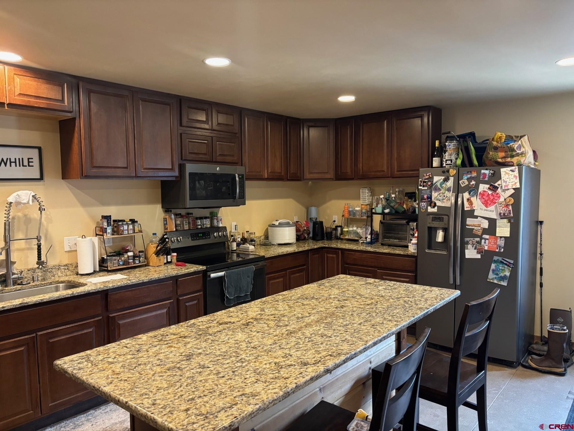 492 Fox Fire Ridge Road Bayfield, CO 81122 - Photo 40 of 44 a kitchen with stainless steel appliances wooden cabinets granite counter tops and a stove