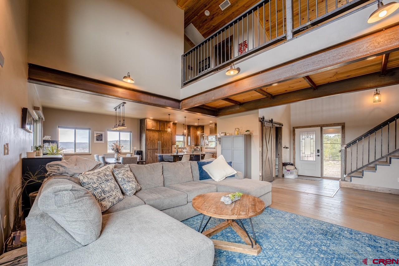 492 Fox Fire Ridge Road Bayfield, CO 81122 - Photo 5 of 44 a living room with furniture and a wooden floor