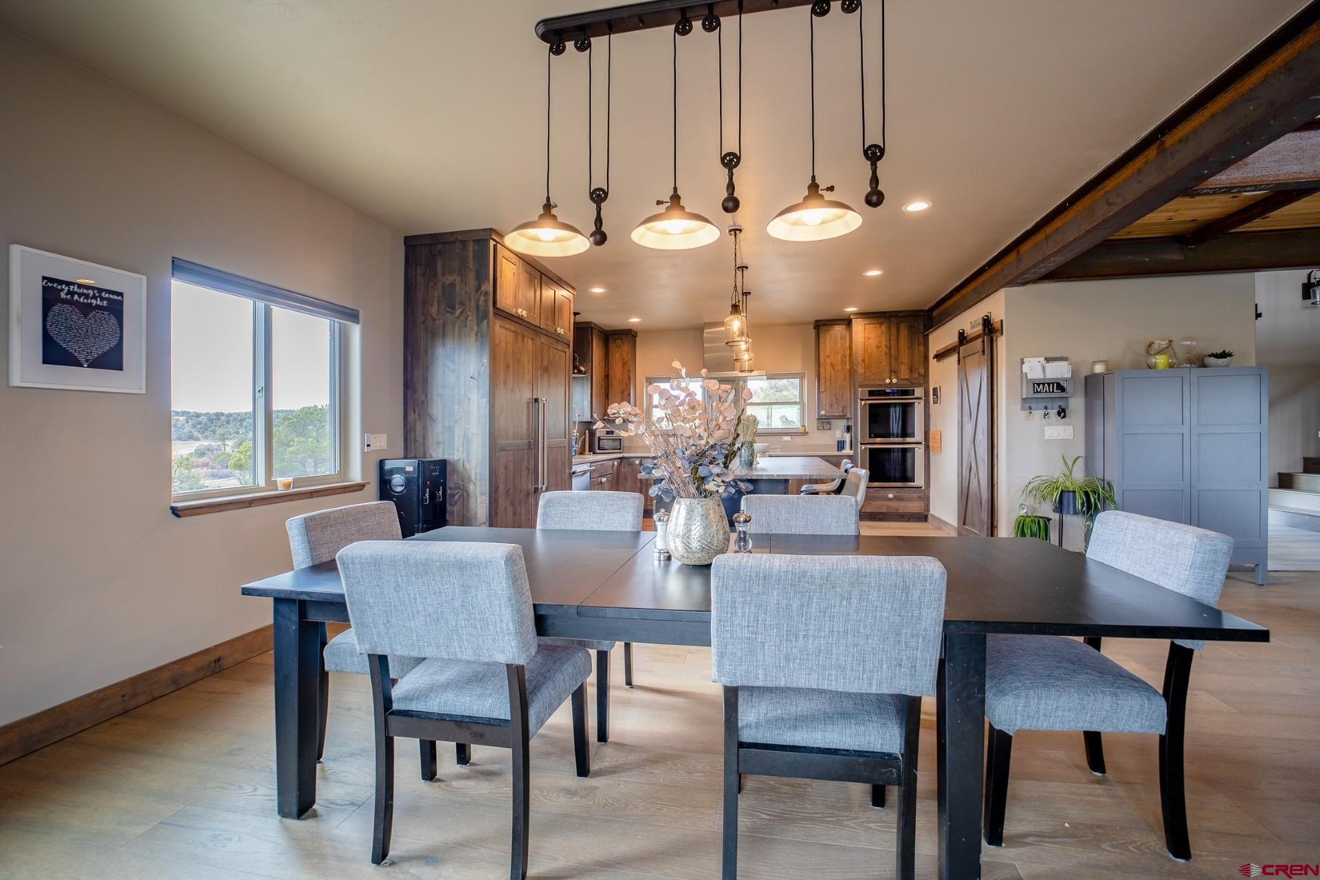 492 Fox Fire Ridge Road Bayfield, CO 81122 - Photo 10 of 44 a view of a dining room with furniture and a chandelier