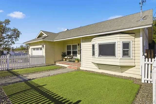 a front view of a house with a garden
