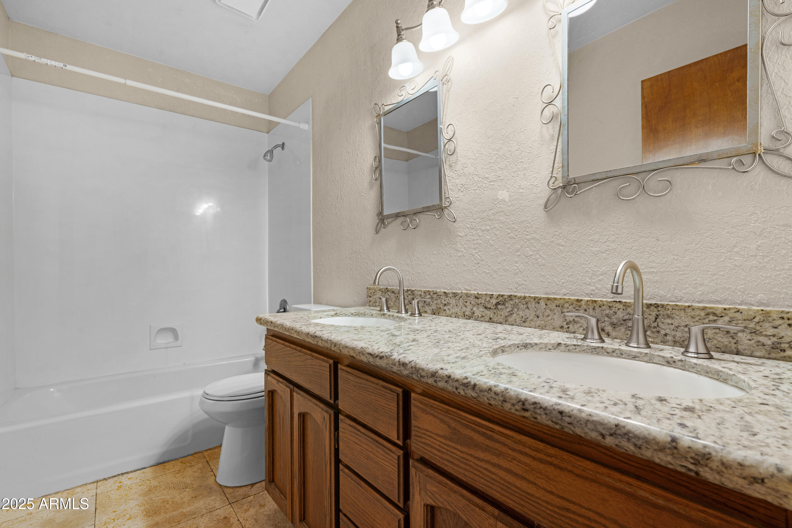 3152 East Irwin Avenue Mesa, AZ 85204 - Photo 24 of 39 a bathroom with a granite countertop sink a toilet and bathtub