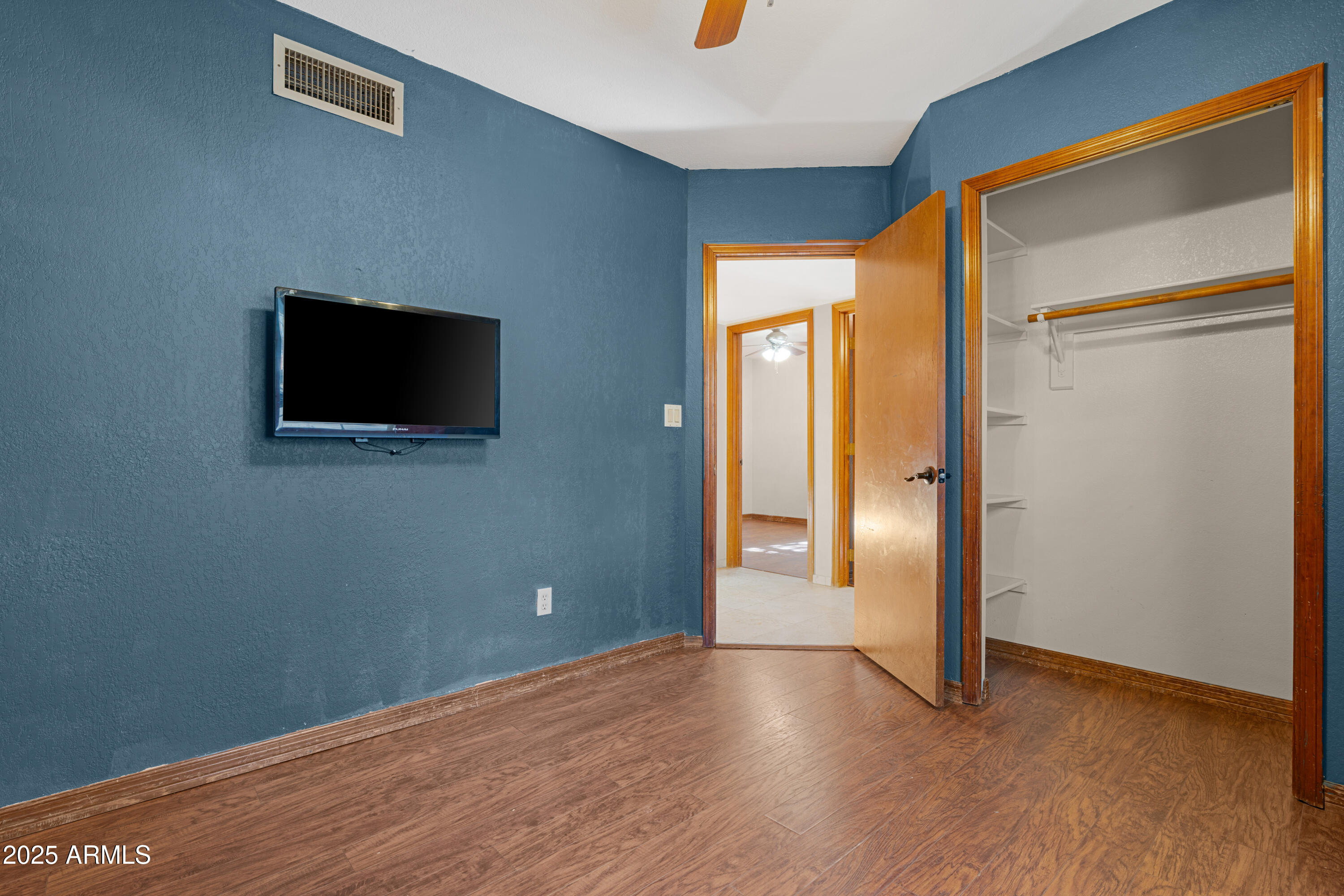3152 East Irwin Avenue Mesa, AZ 85204 - Photo 27 of 39 a view of a livingroom with wooden floor and a flat screen tv