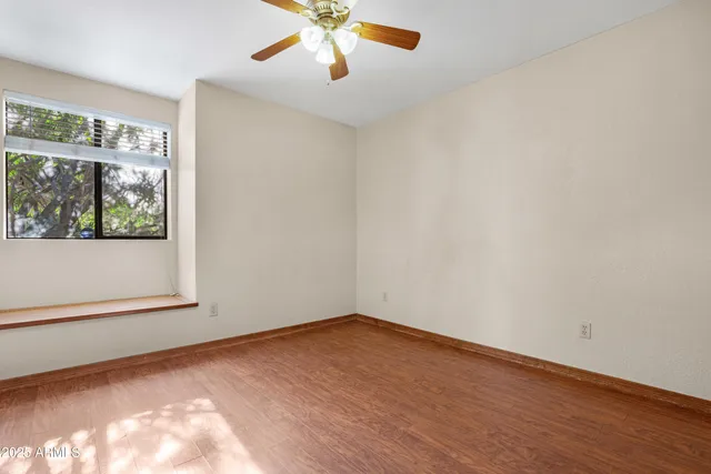 a view of a livingroom with wooden floor and a flat screen tv