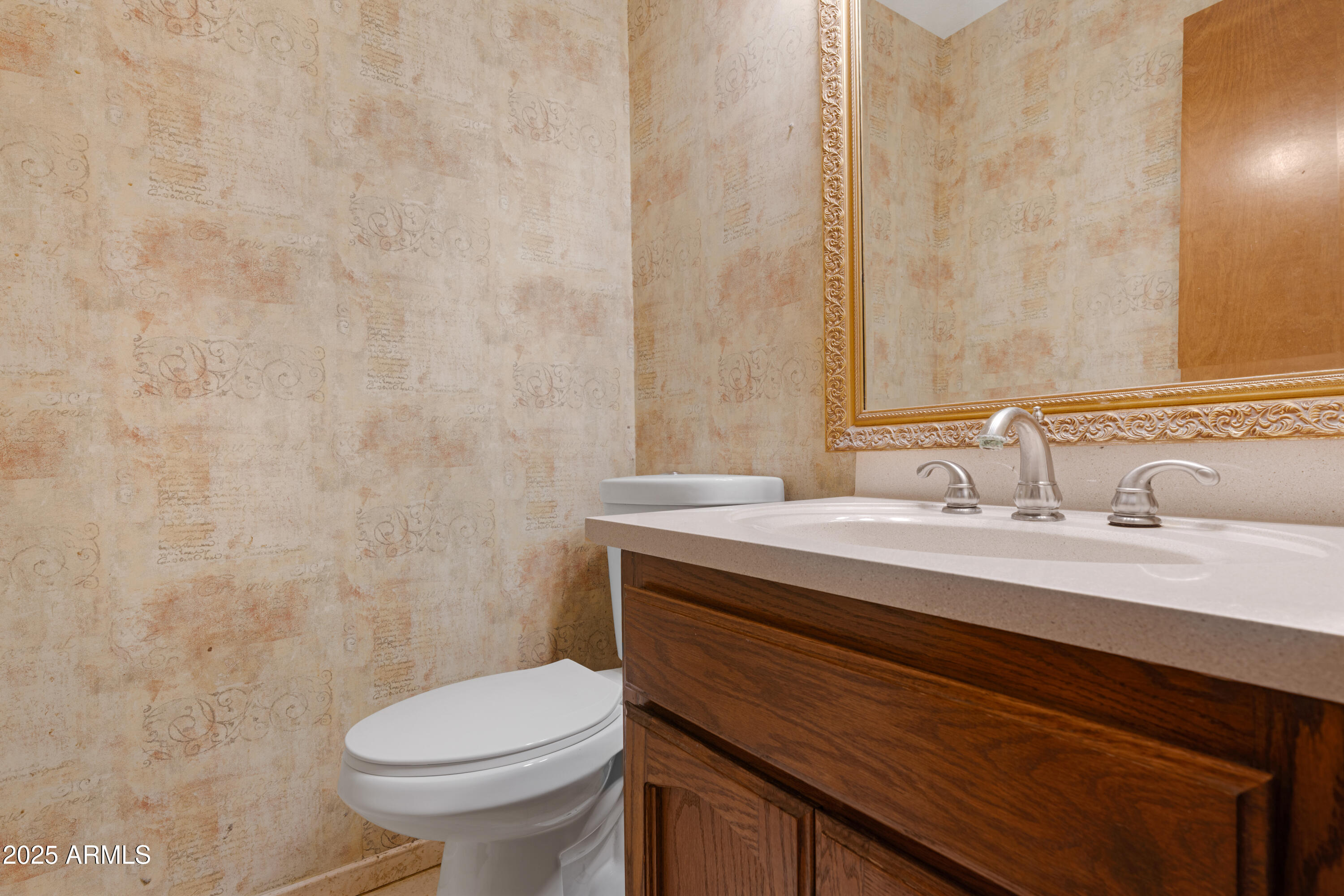 3152 East Irwin Avenue Mesa, AZ 85204 - Photo 29 of 39 a bathroom with a granite countertop sink toilet and a mirror