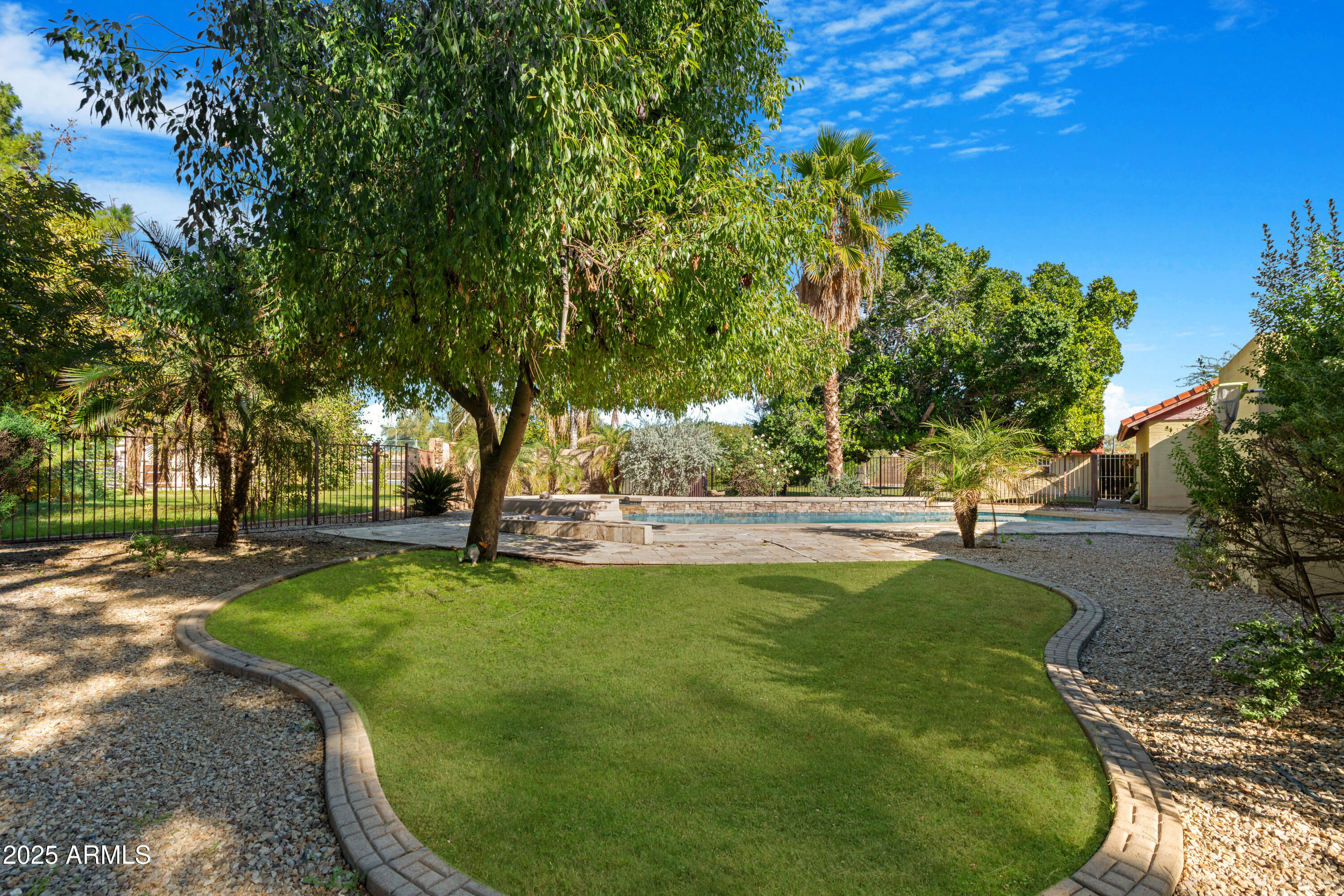 3152 East Irwin Avenue Mesa, AZ 85204 - Photo 34 of 39 a view of a swimming pool in a yard
