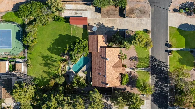an aerial view of a house with a yard