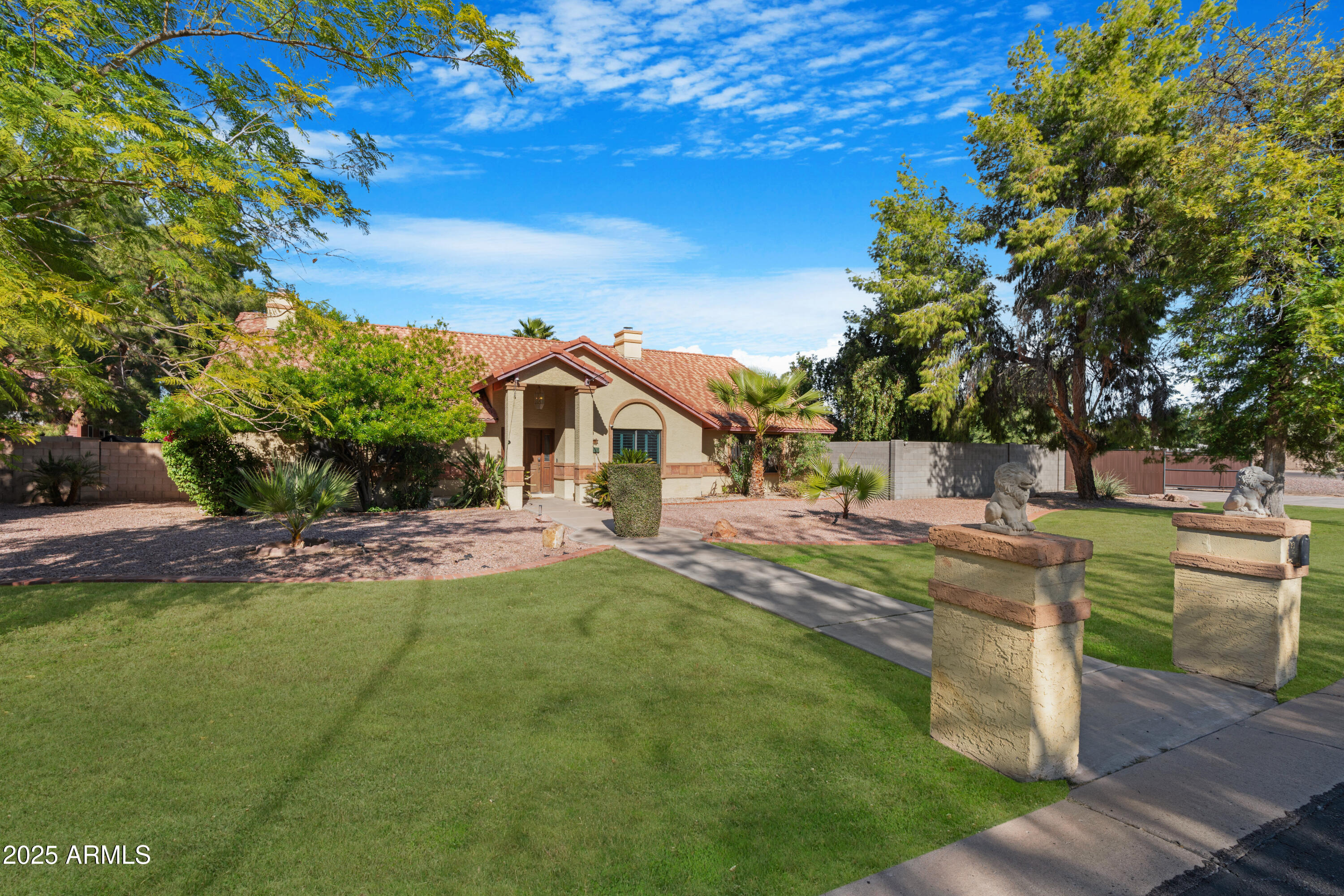3152 East Irwin Avenue Mesa, AZ 85204 - Photo 37 of 39 a front view of a house with a garden