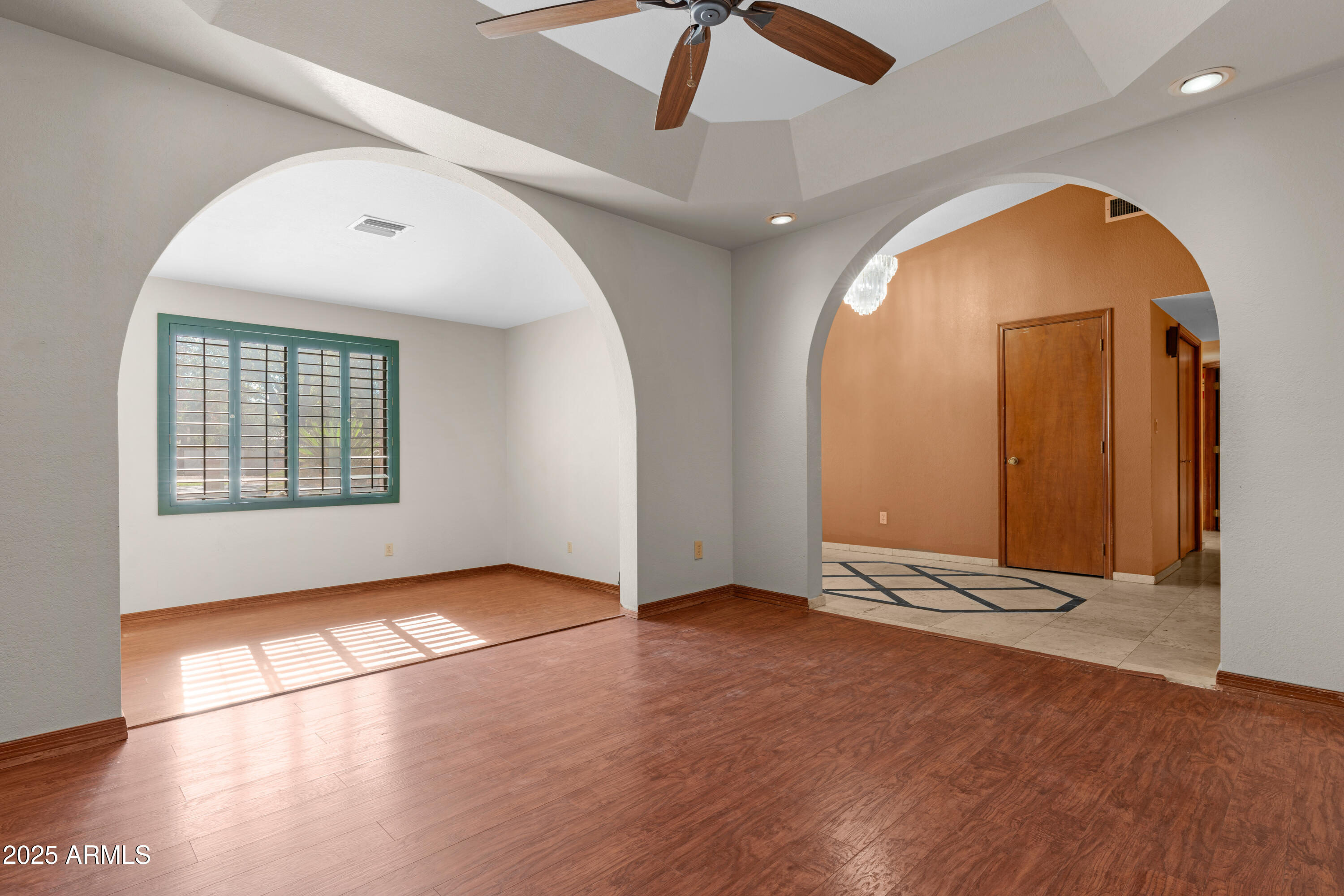 3152 East Irwin Avenue Mesa, AZ 85204 - Photo 7 of 39 an empty room with wooden floor and windows