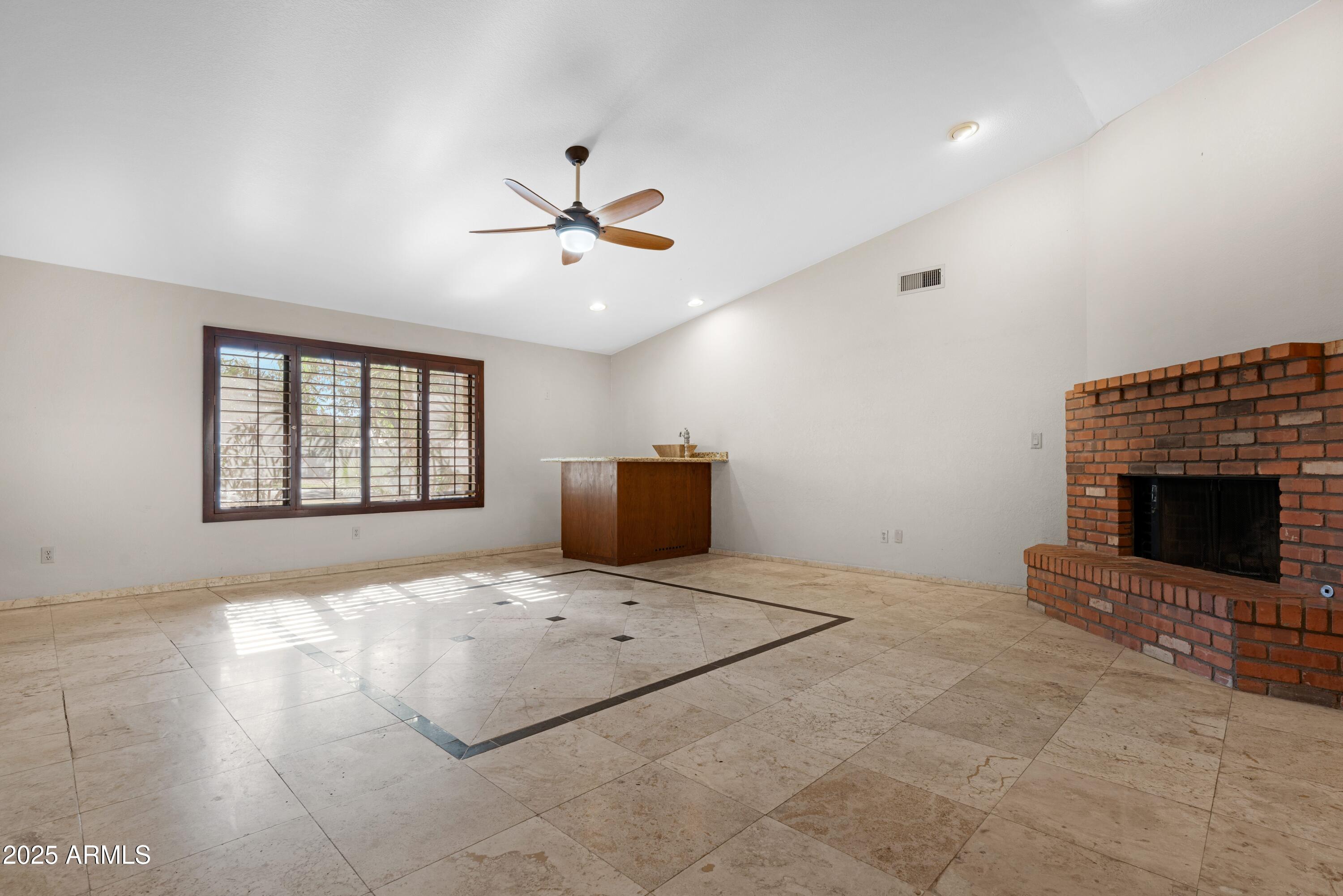 3152 East Irwin Avenue Mesa, AZ 85204 - Photo 8 of 39 a bedroom with a bed and a fireplace