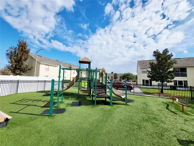 a view of a house with a backyard table and chairs