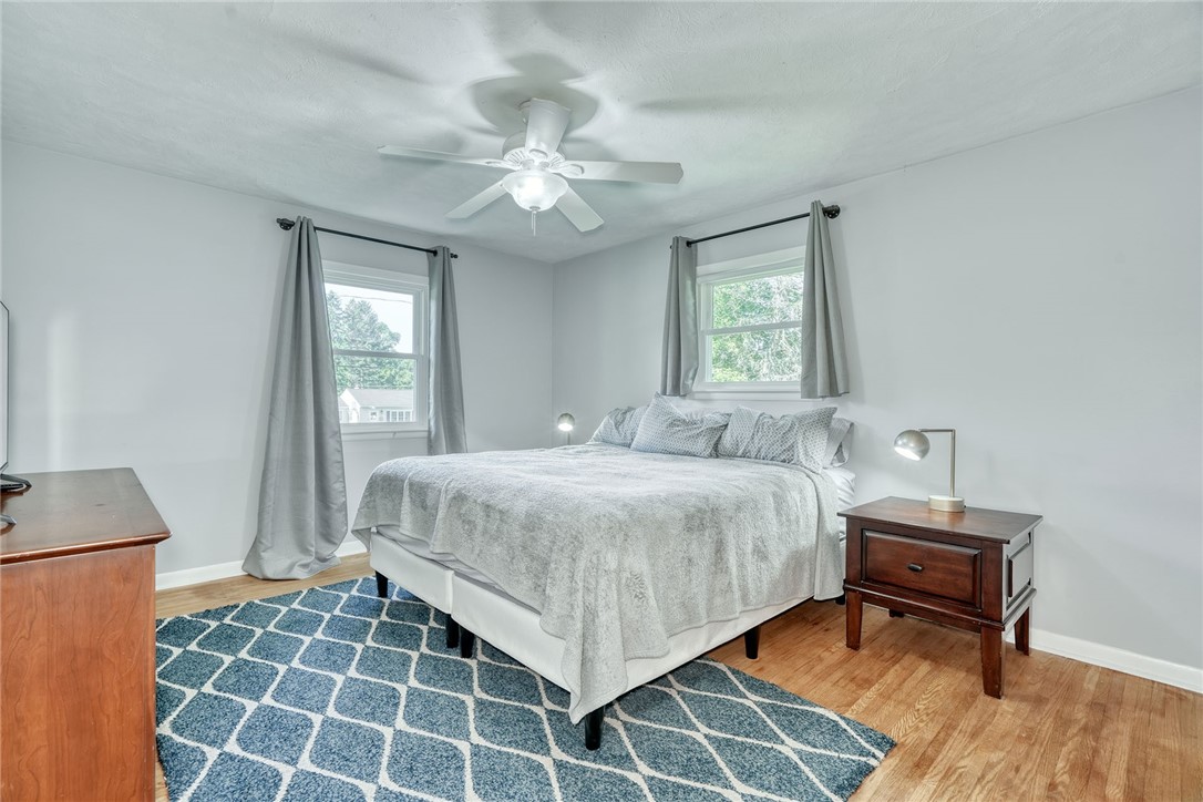 1038 Whalen Road Penfield, NY 14526 - Photo 22 of 46 Primary bedroom with ceiling, fan and hardwood flo