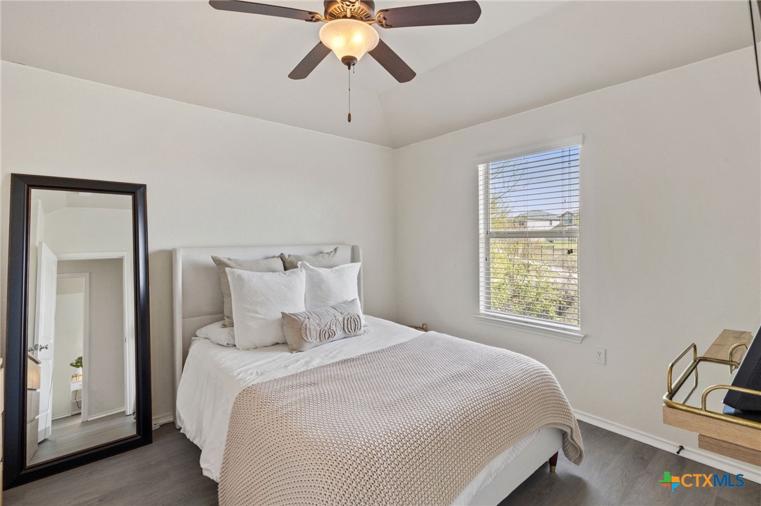 10113 Copper Ridge Cove Austin, TX 78747 - Photo 21 of 32 a bedroom with a bed and window