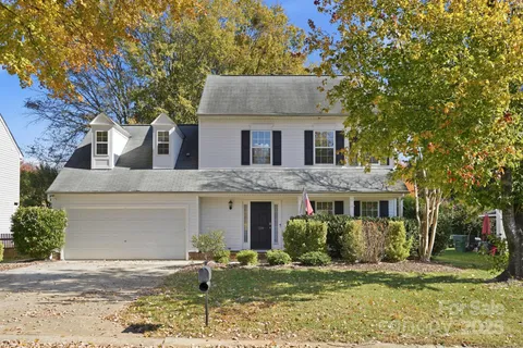 a front view of a house with a yard garage and outdoor seating
