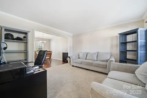 a living room with furniture gym equipment and a flat screen tv