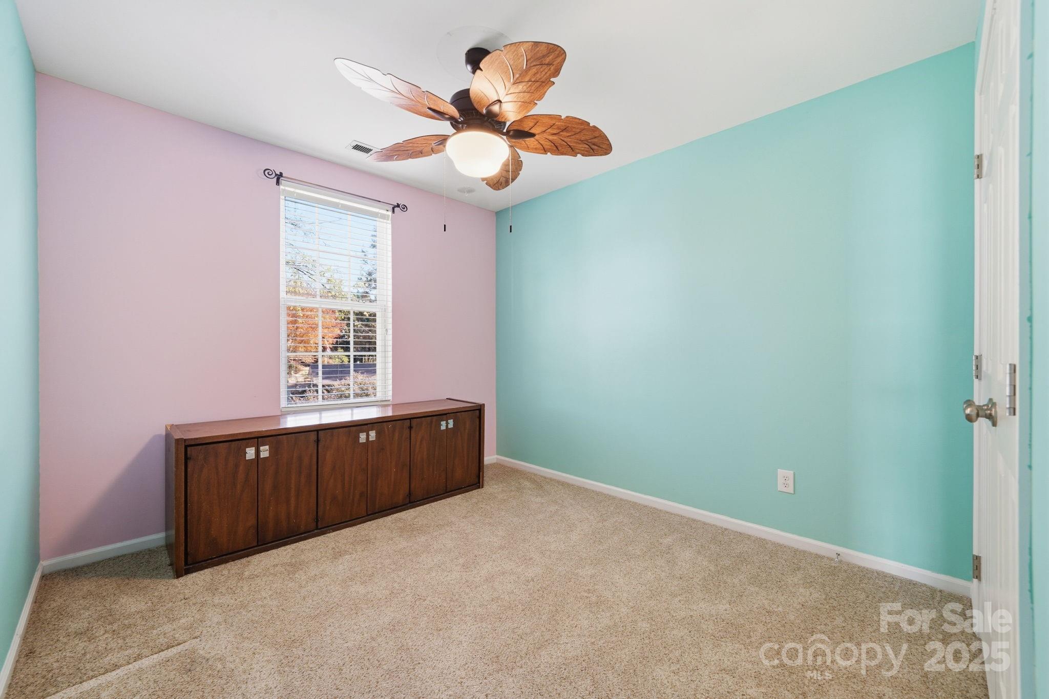 110 Nahcotta Drive Mooresville, NC 28115 - Photo 17 of 29 an empty room with a window and a chandelier fan