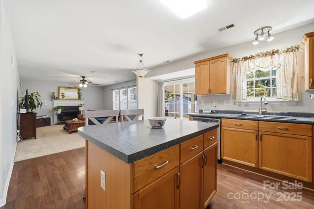 a kitchen with sink cabinets and living room